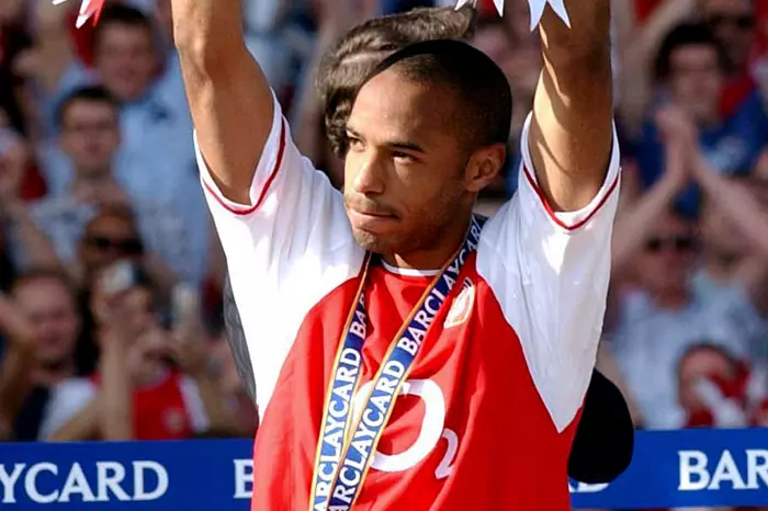 Arsenal's Thierry Henry celebrates with the Barclaycard Premiership trophy after their match against Leicester City at Arsenal's Highbury Stadium, London Saturday May 15 2004.
