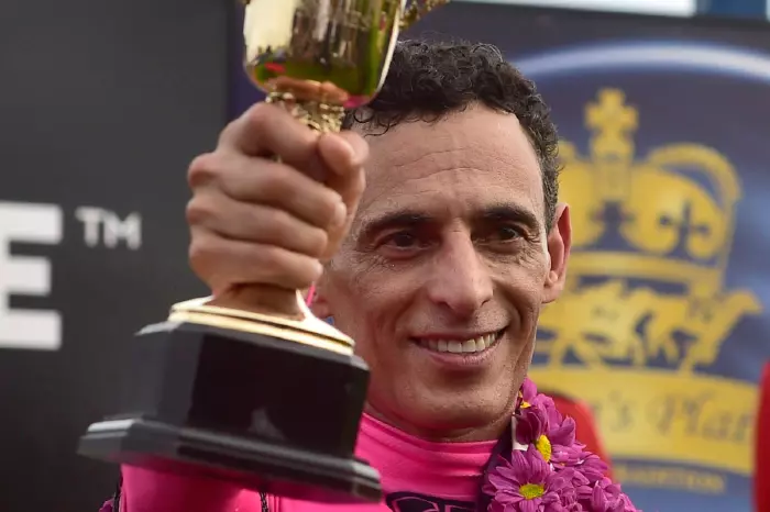 Jockey John Velazquez holding his trophy earned from winning the Queen's Plate at Woodbine Racetrack in Toronto, Canada on 30th June 2018