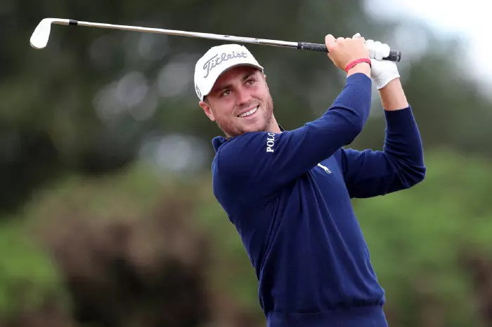 Justin Thomas smiling after nice shot