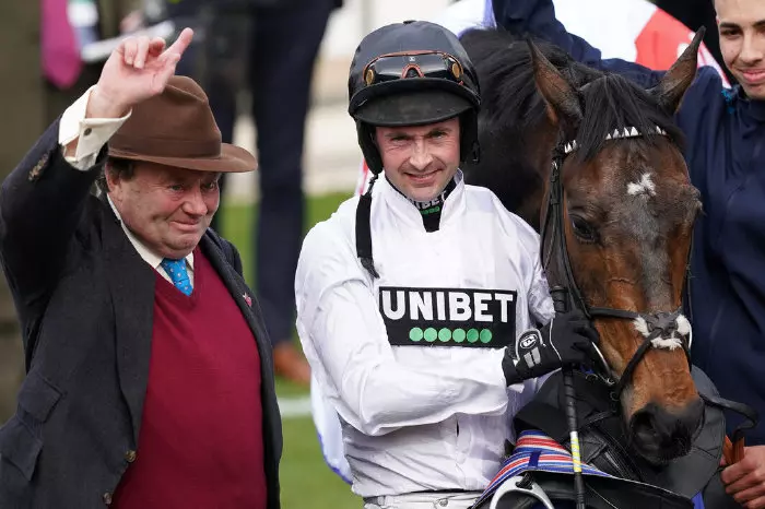 Nico de Boinville and Nicky Henderson celebrate the Supreme Novices Hurdle win on Constitution Hill